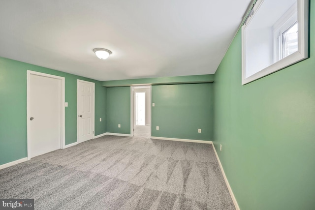 unfurnished bedroom featuring carpet and baseboards