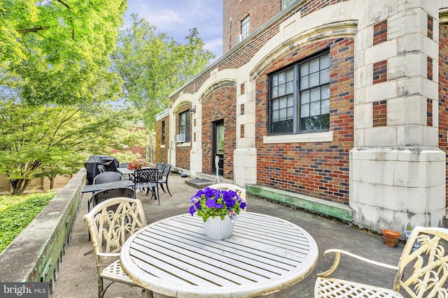 view of patio featuring cooling unit and a grill