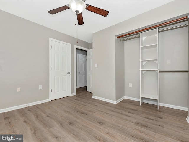 unfurnished bedroom featuring a closet, ceiling fan, and light wood-type flooring