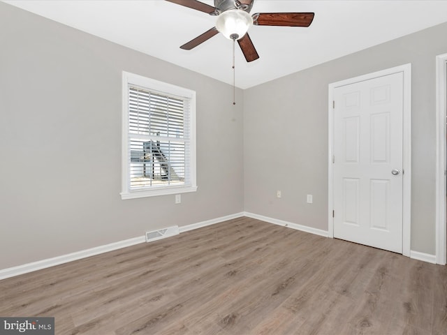 unfurnished room with ceiling fan and light wood-type flooring