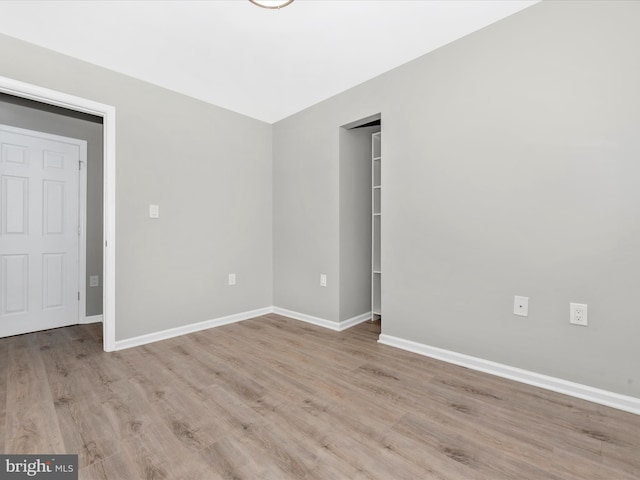 spare room featuring light wood-type flooring