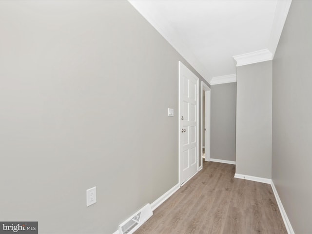 hall featuring ornamental molding and light wood-type flooring