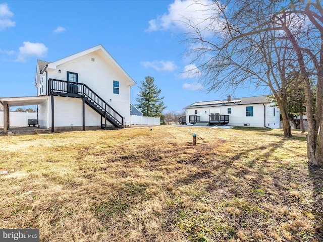 rear view of property with a yard, a patio, and central air condition unit