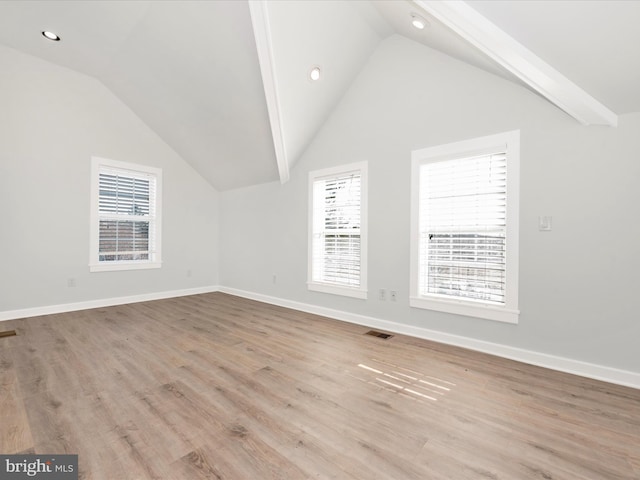 additional living space with lofted ceiling and light hardwood / wood-style flooring