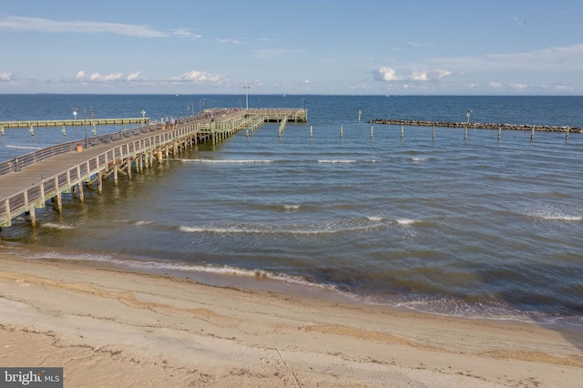 dock area featuring a water view and a view of the beach