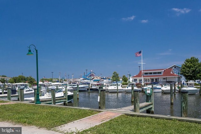 view of dock featuring a water view and a lawn