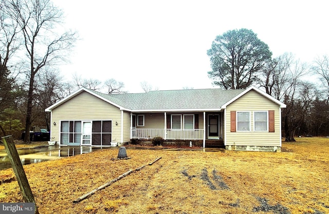 single story home featuring a garage, covered porch, and a shingled roof