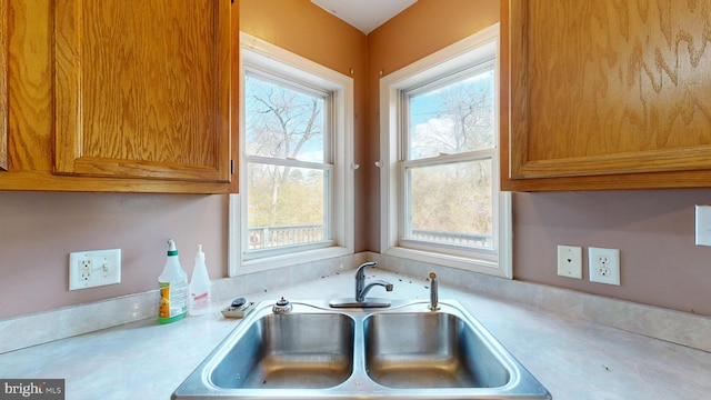 kitchen with brown cabinets, light countertops, and a sink