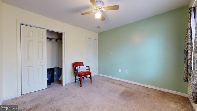 bedroom with light carpet, ceiling fan, baseboards, and a closet