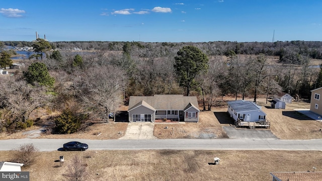 birds eye view of property with a forest view