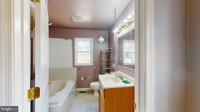 bathroom with visible vents, toilet, tile patterned flooring, vanity, and a bath