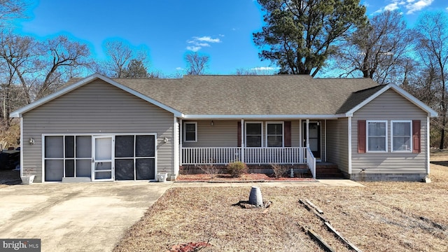 ranch-style house with a garage, concrete driveway, a porch, and roof with shingles