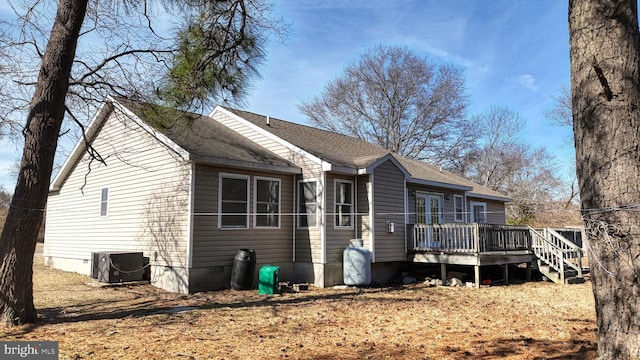 rear view of property featuring a shingled roof, crawl space, a deck, and central AC unit