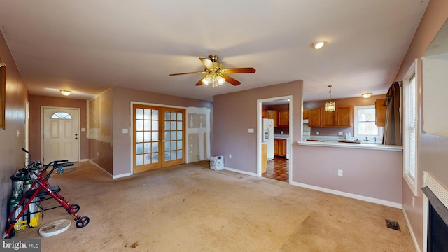 living room with light carpet, baseboards, visible vents, and french doors