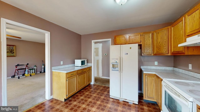 kitchen featuring carpet, light countertops, white appliances, under cabinet range hood, and tile patterned floors