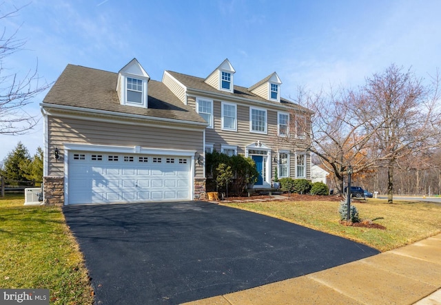 view of front of house with a garage and a front yard