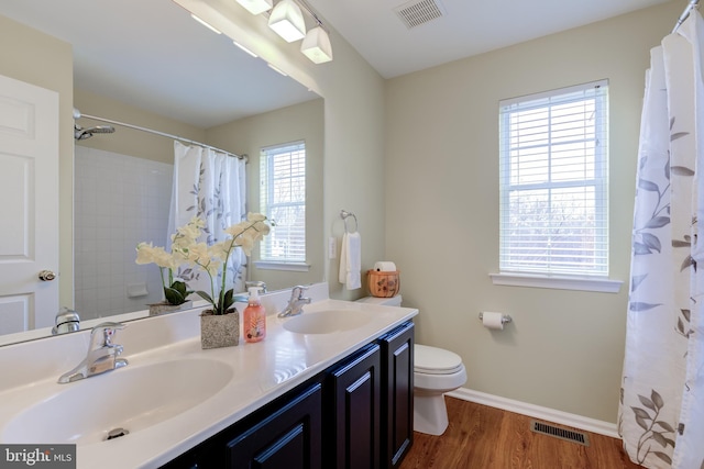 bathroom featuring vanity, hardwood / wood-style floors, a shower with curtain, and toilet