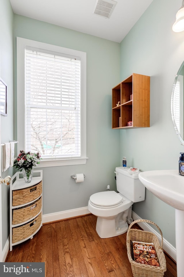 bathroom with sink, toilet, and hardwood / wood-style floors