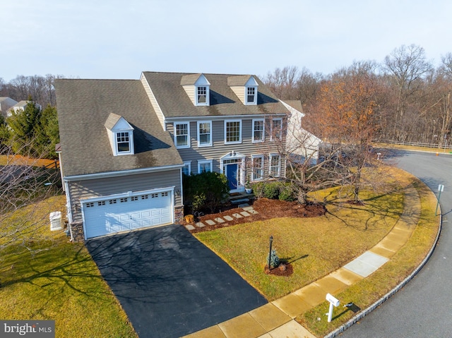 view of front facade with a garage and a front yard