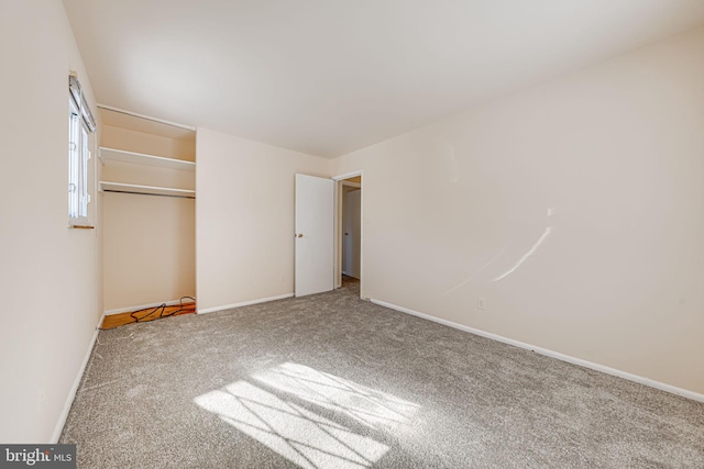 unfurnished bedroom with a closet and carpet flooring