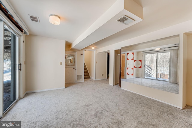 unfurnished room featuring light carpet