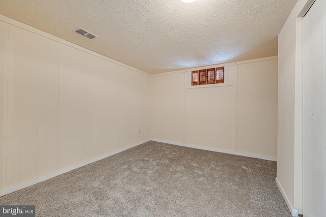 basement with carpet flooring and a textured ceiling