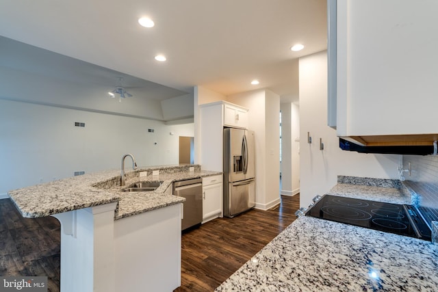 kitchen featuring a breakfast bar area, kitchen peninsula, white cabinets, and appliances with stainless steel finishes