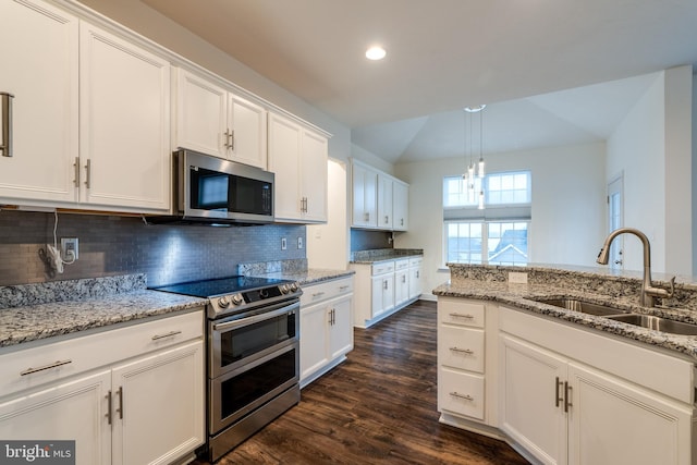 kitchen with sink, white cabinetry, decorative light fixtures, stainless steel appliances, and light stone countertops