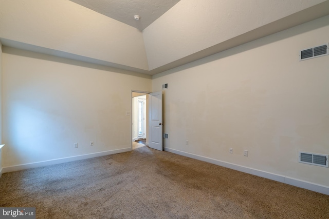 carpeted spare room featuring high vaulted ceiling