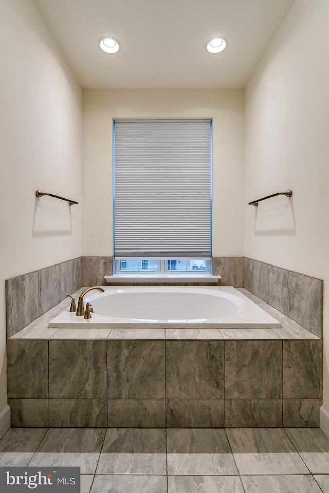 bathroom featuring a relaxing tiled tub