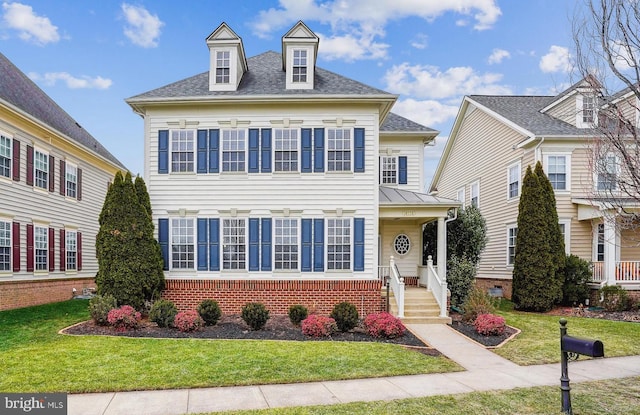 view of front of house featuring a front yard and covered porch