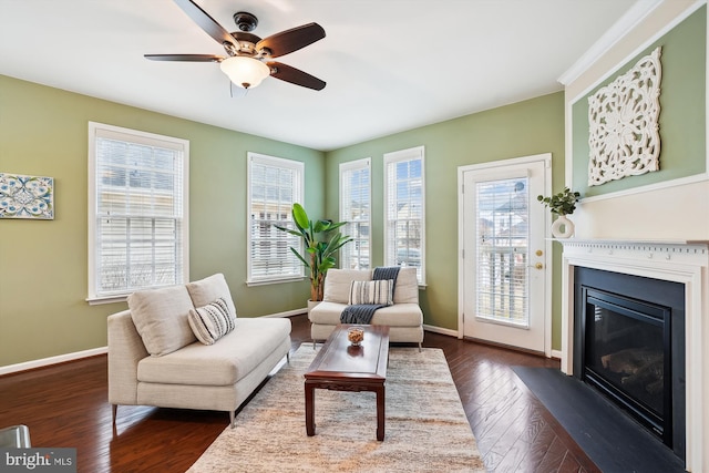 living area featuring dark hardwood / wood-style floors and ceiling fan