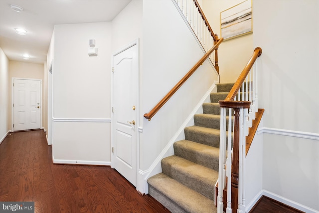 stairs featuring hardwood / wood-style floors