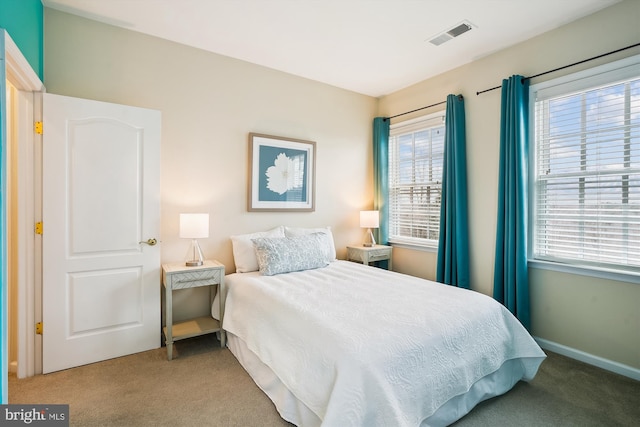 bedroom featuring light carpet