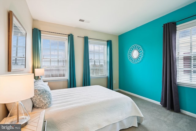 carpeted bedroom with multiple windows