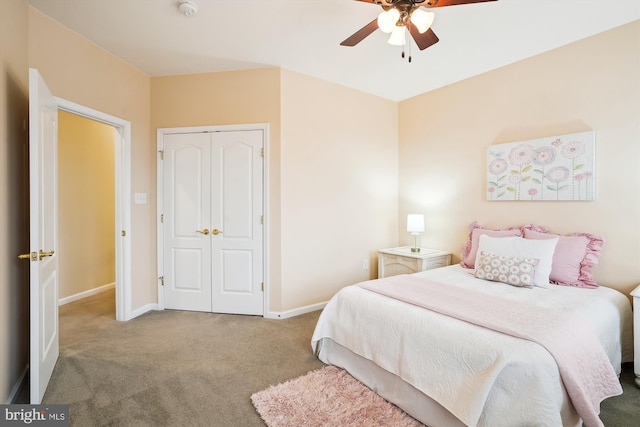 carpeted bedroom featuring ceiling fan and a closet