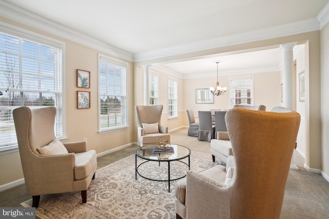 sitting room featuring ornamental molding, a chandelier, decorative columns, and light carpet