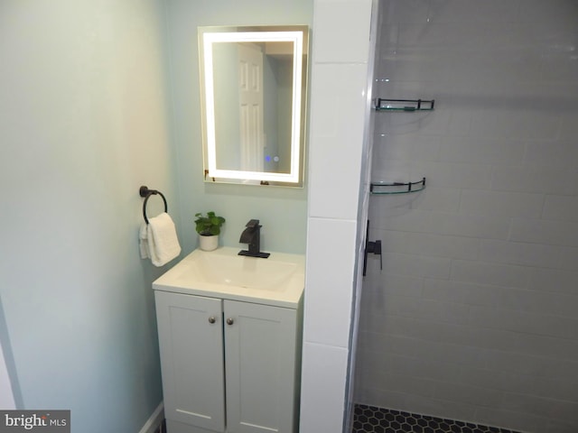 bathroom with vanity and a tile shower