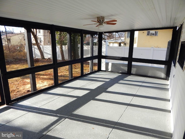 unfurnished sunroom featuring ceiling fan