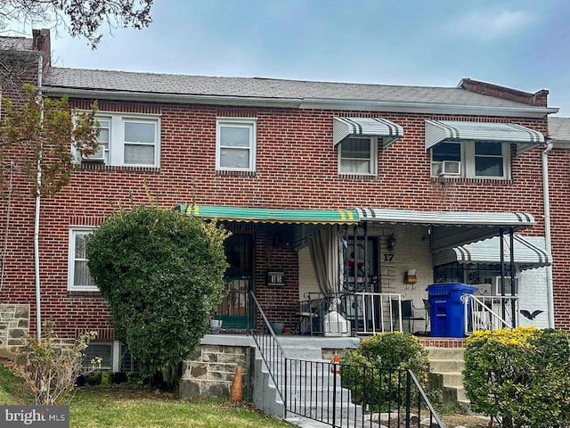 multi unit property with brick siding and covered porch