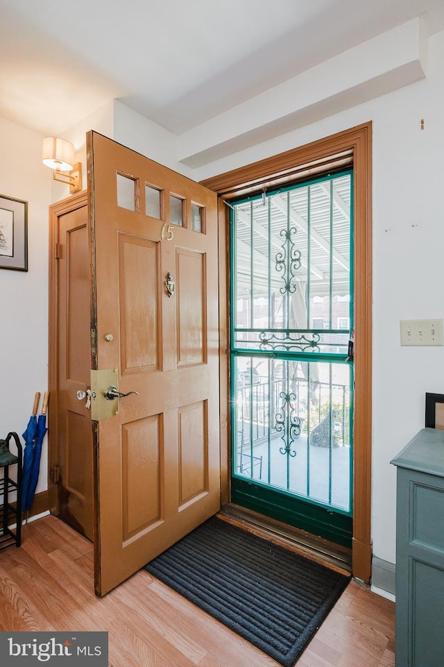 foyer featuring baseboards and light wood-style flooring