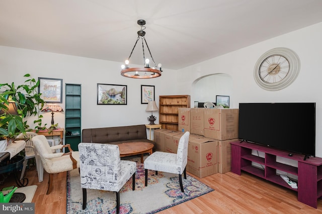 living room featuring an inviting chandelier and wood finished floors