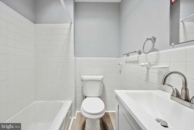 full bathroom with hardwood / wood-style flooring, vanity, tile walls, and toilet