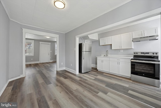 kitchen featuring appliances with stainless steel finishes, light hardwood / wood-style flooring, and white cabinets