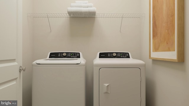 laundry room with cabinets and washing machine and clothes dryer