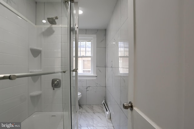 bathroom featuring a baseboard radiator, toilet, and tile walls