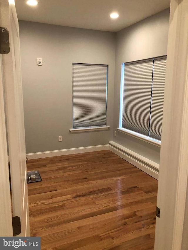 empty room with hardwood / wood-style floors