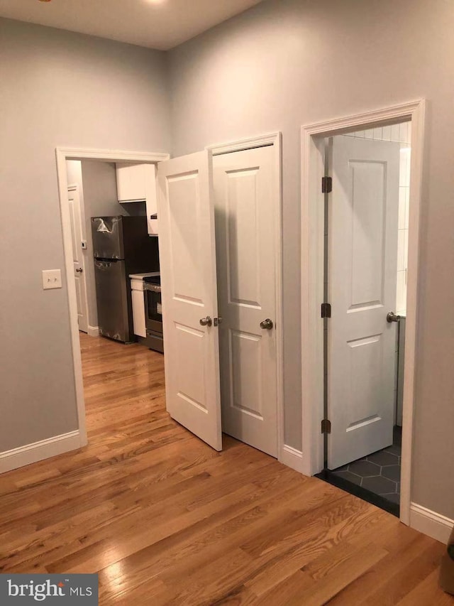 hallway with wood-type flooring