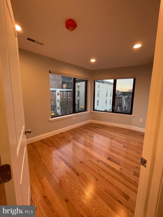 empty room with mail boxes and hardwood / wood-style flooring