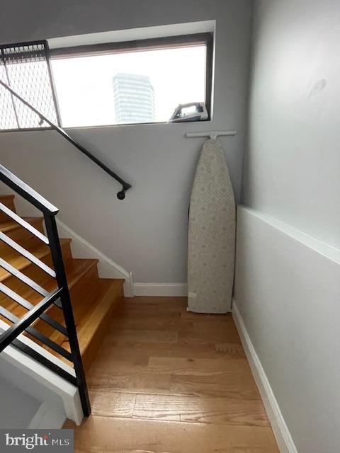 stairs with hardwood / wood-style flooring